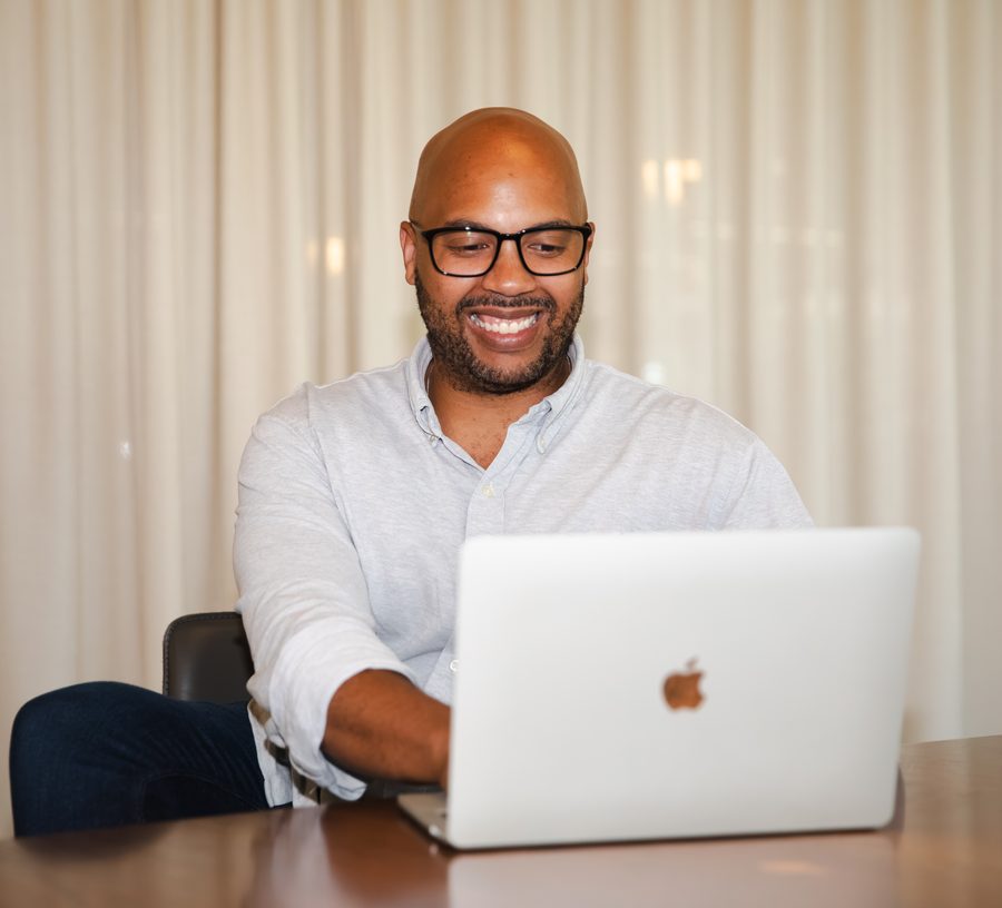 LaSean from Communications working at a laptop